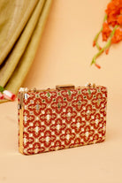 Decorative clutch bag with intricate patterns on a beige background