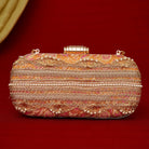 Decorative clutch bag with intricate patterns on a red background