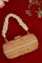 Decorative handbag with pearl handle on a red background