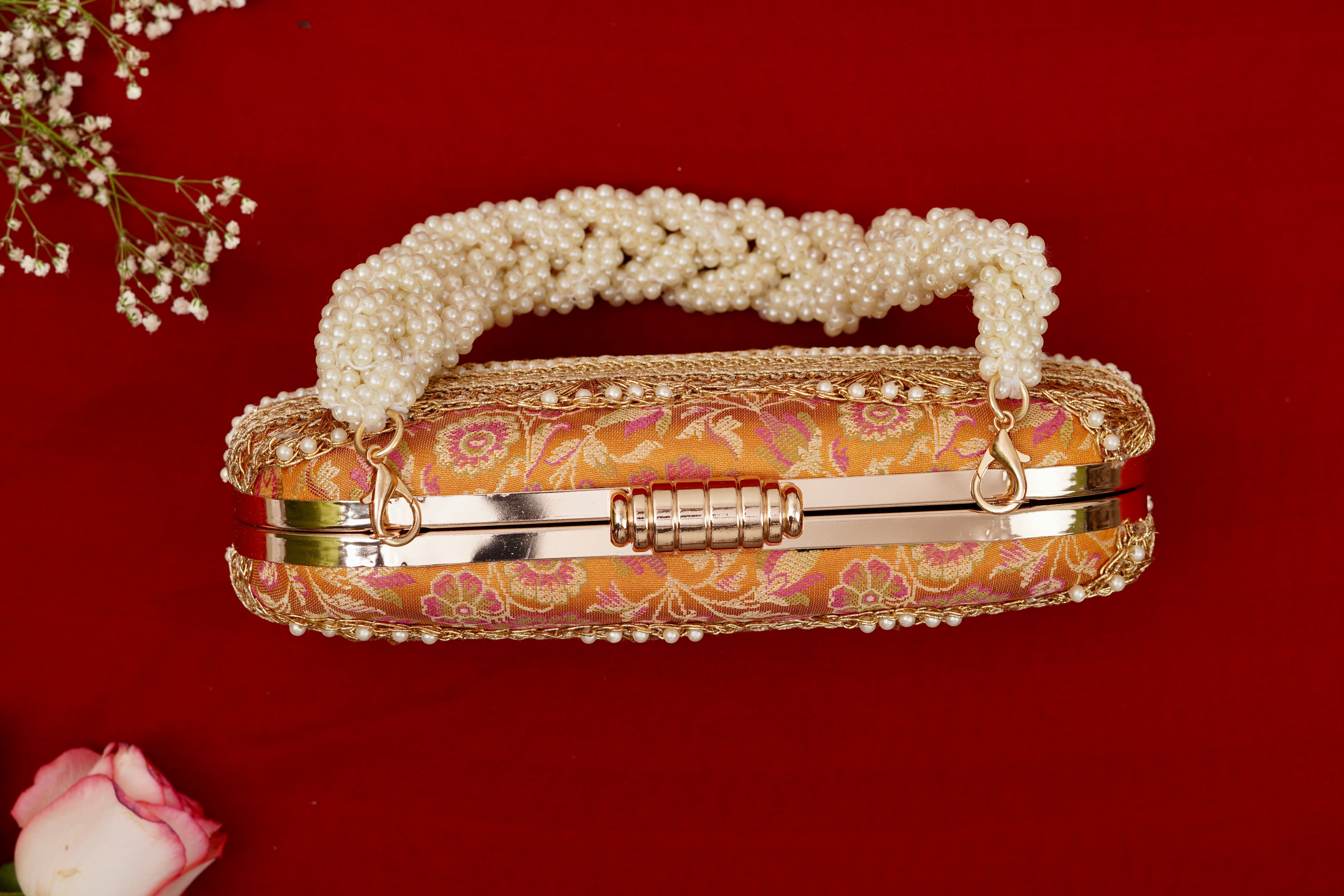 Decorative handbag with pearl handle on a red background